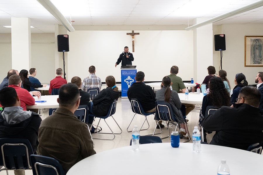 Father Brett Metzler speaks at a YCP speaker series event
